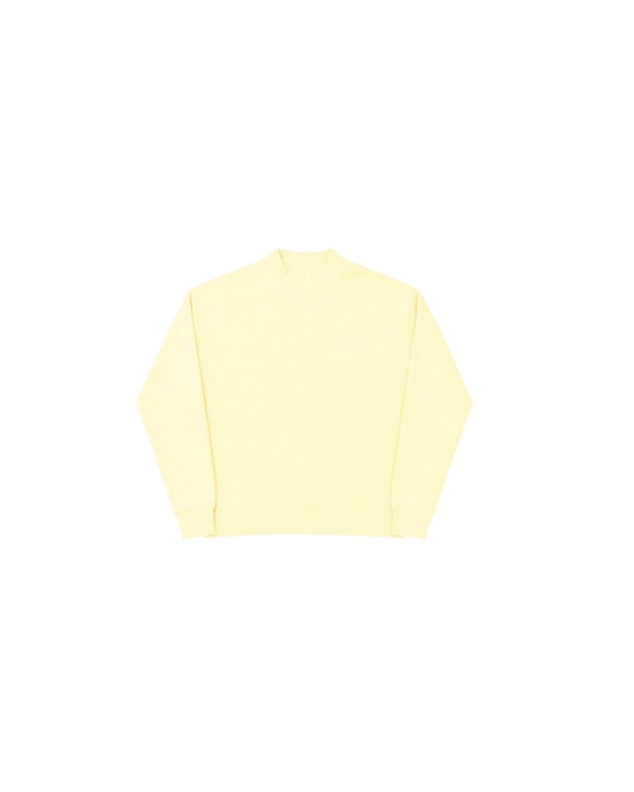 Light yellow mockneck sweater with long sleeves and a relaxed fit, simple and casual style.