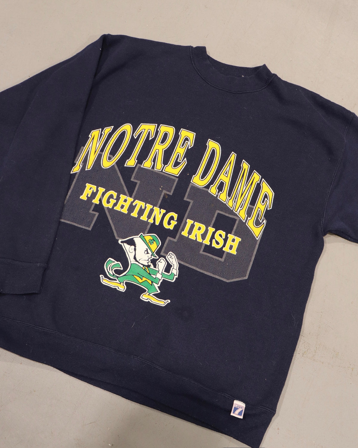 Vintage navy crewneck sweatshirt with Notre Dame Fighting Irish graphic and leprechaun artwork