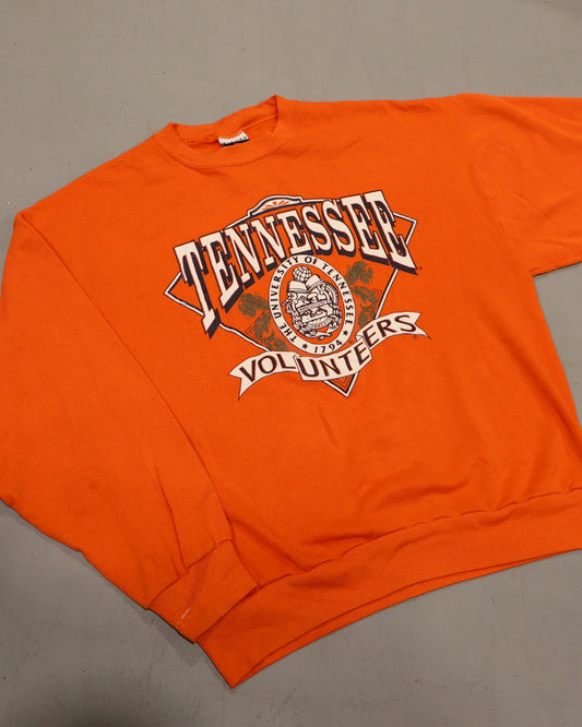 Vintage orange Tennessee Volunteers crewneck sweatshirt with bold collegiate graphic and ribbed cuffs