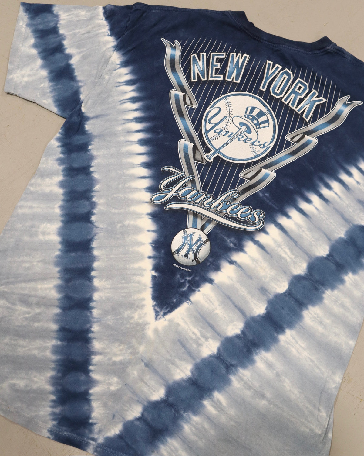 Blue and white tie dye tee with a vintage New York Yankees graphic and baseball emblem