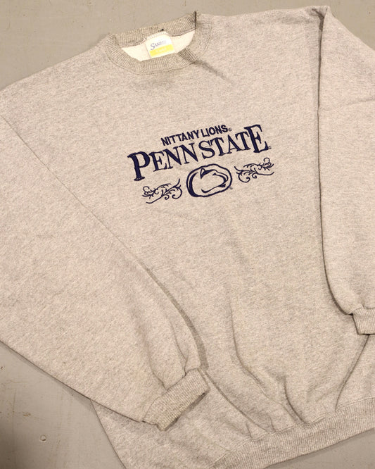 Vintage heather gray Penn State crewneck sweatshirt with navy collegiate lettering and ribbed cuffs
