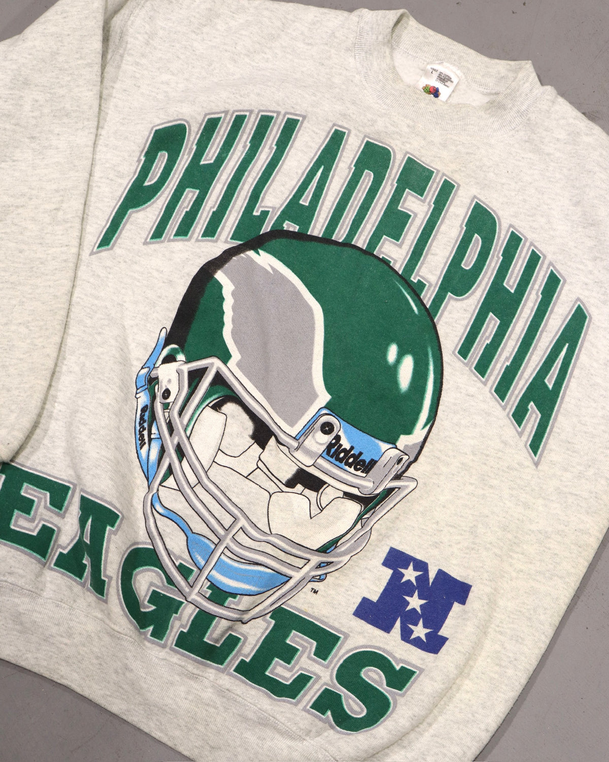 Vintage gray Philadelphia Eagles tee with green lettering and football helmet graphic