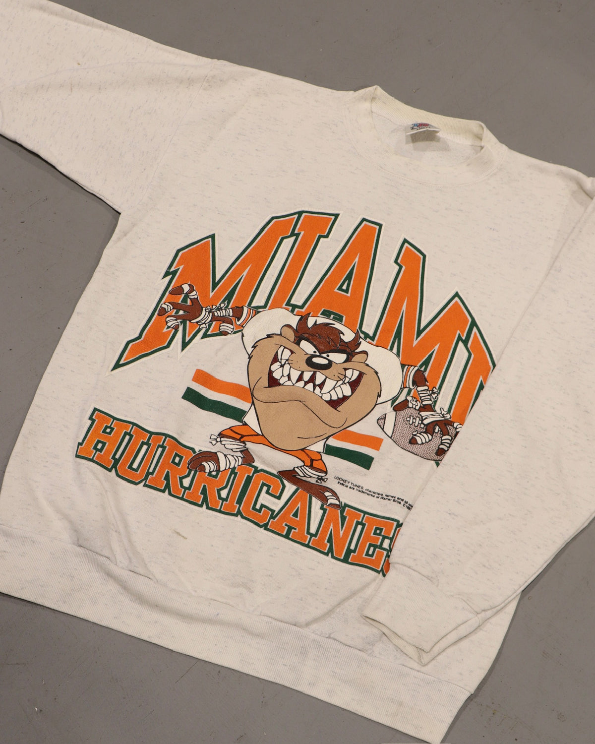 Cream vintage crewneck sweatshirt featuring a Miami graphic with a cartoon character and bold orange lettering