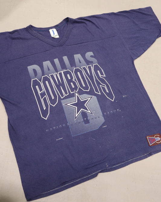 Purple Dallas Cowboys graphic tee with bold layered lettering and star logo on the front