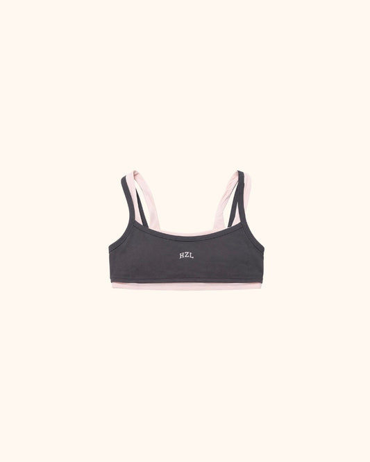 Slate grey sports bra with pale pink straps and a small HZL logo