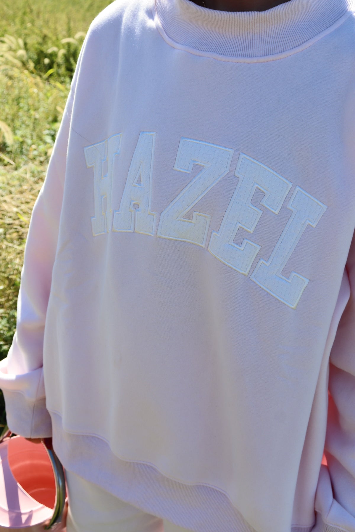 Pale lavender mockneck sweatshirt with raised HAZE lettering