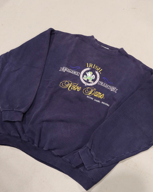 Vintage navy crewneck sweatshirt with Irish themed Notre Dame graphic and ribbed cuffs