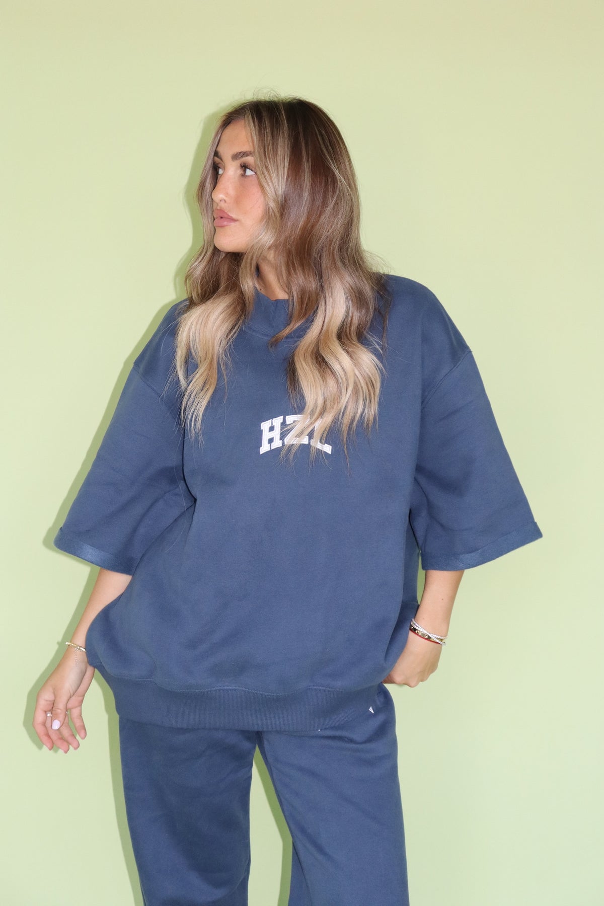 Model wearing a navy HZL short sleeve mockneck top with matching pants