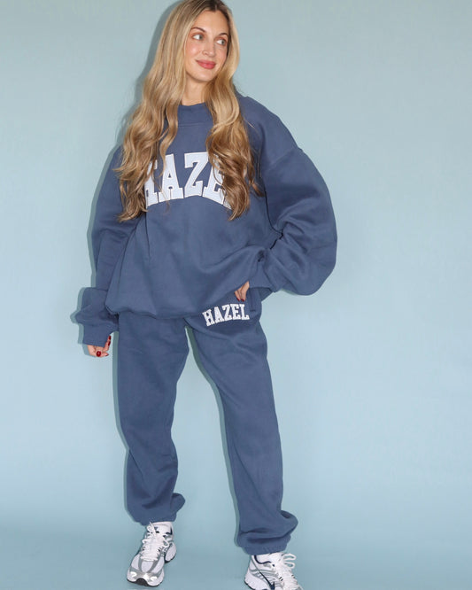 Model wearing navy Hazel joggers with a matching oversized sweatshirt and sneakers