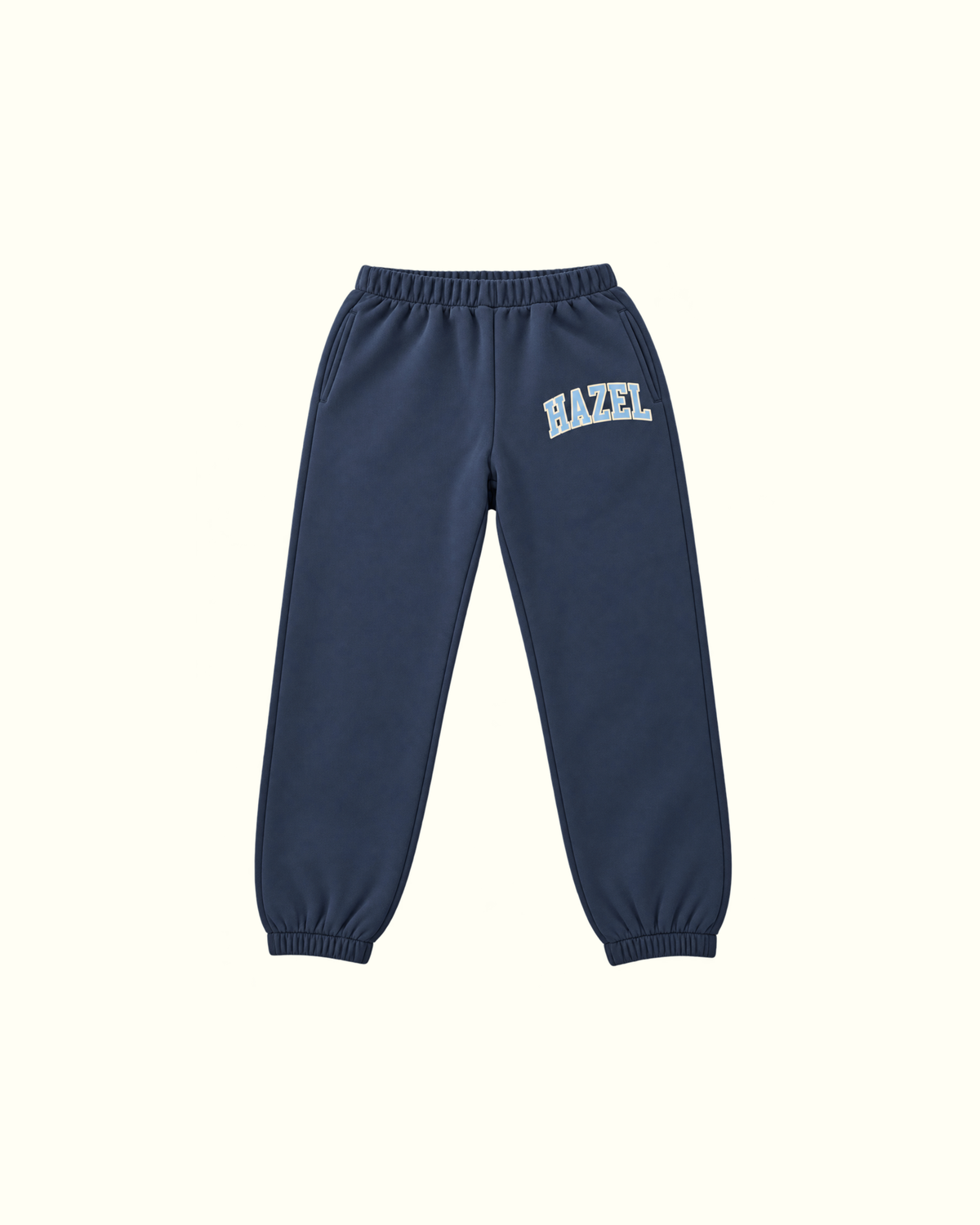 Navy jogger pants with an elastic waistband and cuffs and bold Hazel lettering on the upper leg
