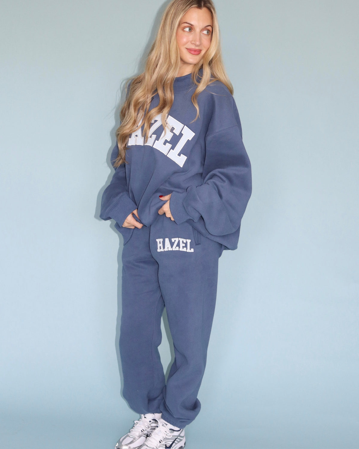 Model wearing blue Hazel joggers with a matching oversized sweatshirt and sneakers
